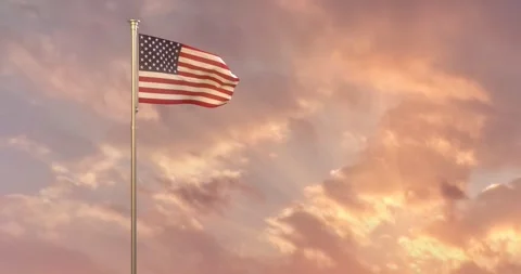 The National Flag of the U.S.A. against a background of setting sun with sunrays Stock Footage 240263227