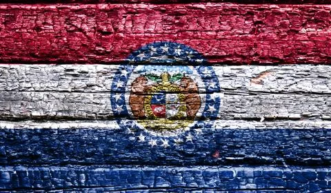 The national flag of the US state Missouri in against a black charred wooden  Stock Photos