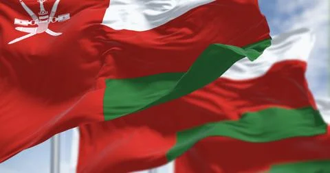 National flags of Oman waving in the wind on a clear day Stock Illustration