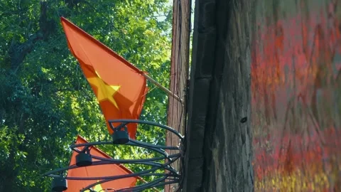 National flags of Vietnam flutter in the wind, reflected on the glossy wall Stock Footage 303180847
