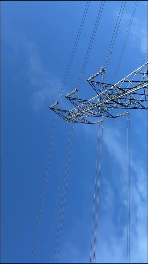 National grid pylon against a clear blue sky, England, UK Video stock 287475014