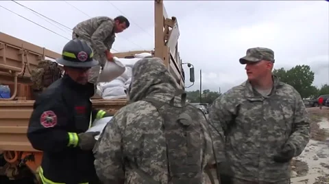 National Guard workers pile sandbags during a severe storm. Stock Footage