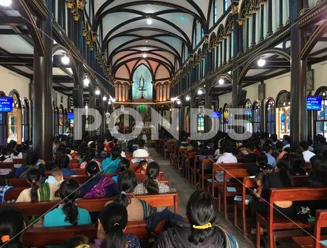 National minorities in Roman Catholic wooden Cathedral of Kon Tum, Vietnam Stock Photos
