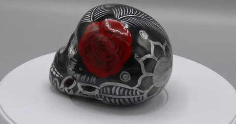 Native American Ceramic Skull - Rotating - Black With A Red Rose - Wide Stock Footage 124998235