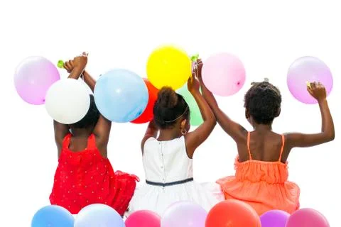 Native american  children sitting together holding color balloons. Stock Photos