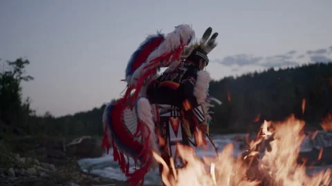 Native American Indigenous Dancing by the fireplace at sunset in Alberta Canada  Stock Footage 250024768