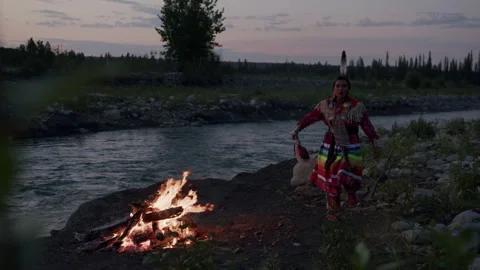 Native American Indigenous Dancing by the fireplace at sunset in Alberta Canada  Stock Footage 250834122