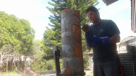 Native American man carving a design into a log-wide shot Stock-Footage 35753437