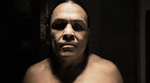 Native American mixed martial arts athlete looks intently into the camera Vídeos de archivo 33866488