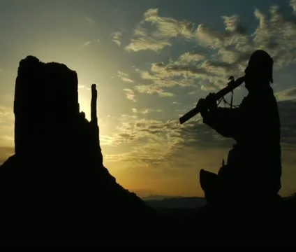 Native American playing flute with Monument Valley sunrise 스톡 동영상 21663898