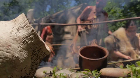 Native American Women using primitive tools to prepare food over an open fire. Stock Footage 196262757