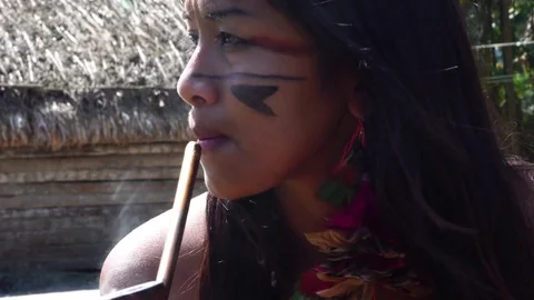 Native Brazilian woman from Tupi Guarani tribe smoking pipes, Brazil Stock Footage