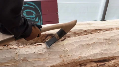 Native carvers in Hoonah, Alaska, prepare a totem pole honoring local fishing Stock Footage 310728478