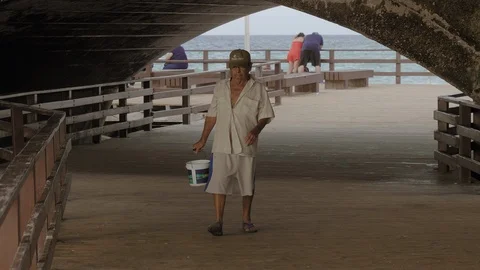 NATIVE FISHERMAN WITH BUCKET PUERTO PROGRESO LIFE IN MERIDA YUCATAN Stock Footage 100793290