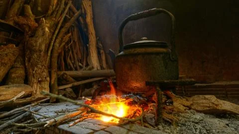 Native image pot of water on burning fire. Stock Photos