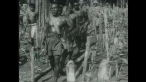 Native New Guineans teach American troops how to fight in World War Two. Stock Footage 101693164