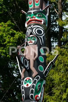 Native people totem pole. Handcrafted representation of unique culture. Stock Photos