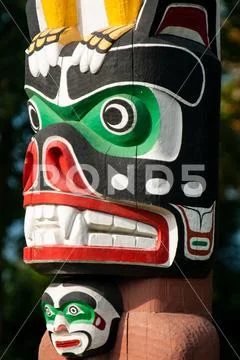 Native people totem pole. Handcrafted representation of unique culture. Stock Photos