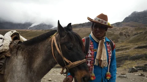 Native Peruvian riding on horses  in the Rainbow Mountain, Peru Stock Footage 125282627