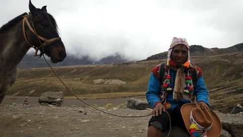 Native Peruvian riding on horses  in the Rainbow Mountain, Peru Stock Footage 125282654