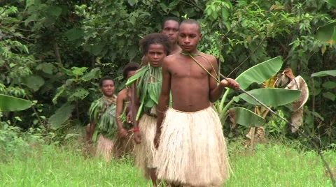 Natives Walking Through Jungle Stock Footage 3434574