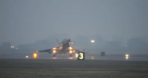 NATO Combat Airplane Lands at Sunset with Grey Sky Background. Light Reflexions 库存影片 235185058