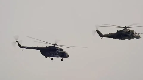 NATO military attack helicopter Mil Mi-35 and Mil Mi-171Sh air force flying in Stock Footage 337202902