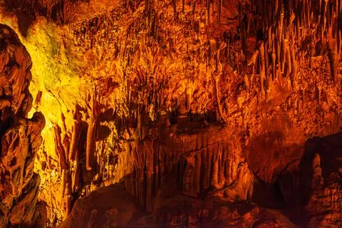 Natural abstract texture with sharp spikes of stalactites on the ceiling of Stock Photos