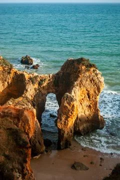Natural arch in the sunset at the coast of Portugal Stock Photos