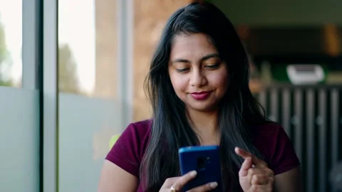 Natural Asian Woman Using Mobile Phone In Coffee Shop Stock Footage 163961381