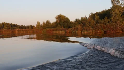 Natural background view of waves from a boat at sunset Stock Footage 283462522