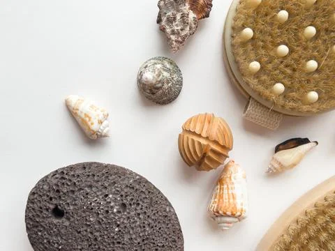 Natural bath essentials with sea shells and exfoliating tools on white Stock Photos
