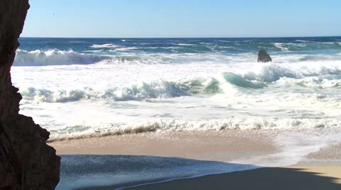 Natural beach scene with large waves and cliff Stock Footage 43097860