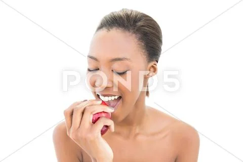 Natural beauty with closed eyes biting apple Stock Photos