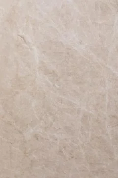Natural beige marble surface with subtle veining pattern for home decor and Stock Photos