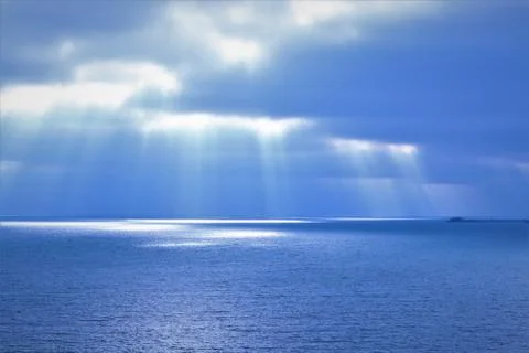 Natural blue background - sea, sky, clouds, sun fingers Stock Photos
