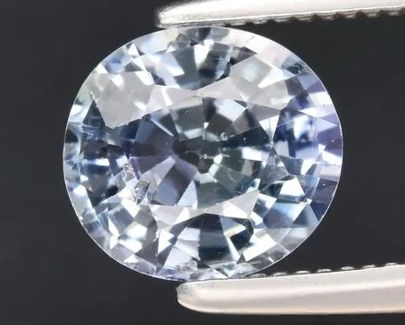 Natural blue tanzanite gem on the background Foto stock