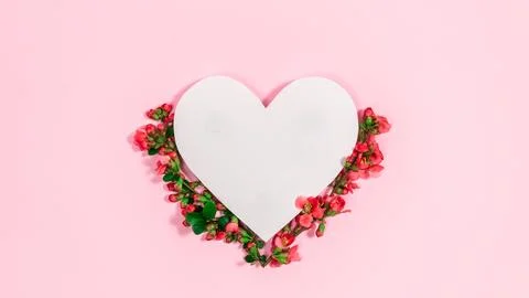 Natural branches with spring red buds and flowers near white paper heart. Con Stock Photos