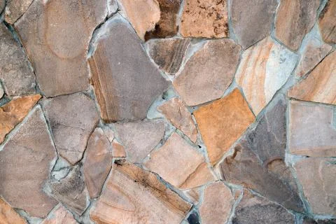 Natural building material, multi-colored sandstone wall texture Stock Photos