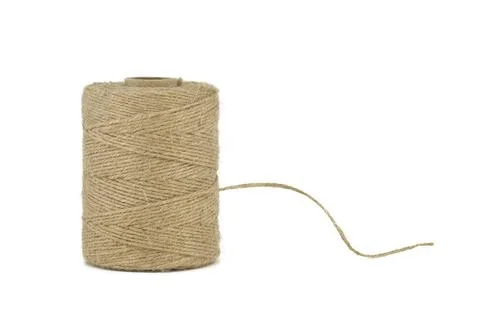 Natural burlap thread or jute twine roll in close-up isolated on white 写真素材
