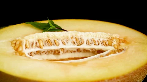 Natural cantaloupe melon composition with basil on reflective black surface Stock Footage 340416134