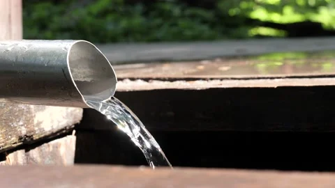Natural clean water flows from the source of the spring Stock Footage 157749470