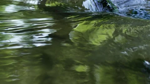 Natural clear water flows over the edge of the rock Stock Footage 234956103