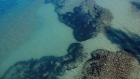 Natural coastal seabed patterns beneath crystal clear blue sea Stock Footage 343997765