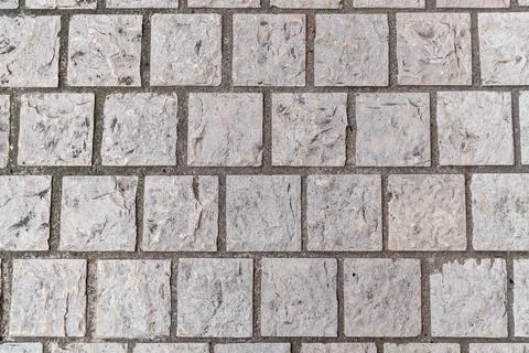 Natural cobblestone pavement with textured pattern Stock Photos