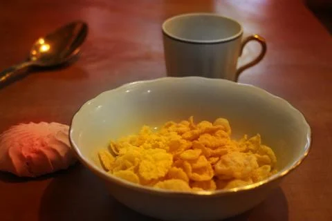 Natural corn flake breakfast cereal in cups and milk a light easy breakfast Stock Photos