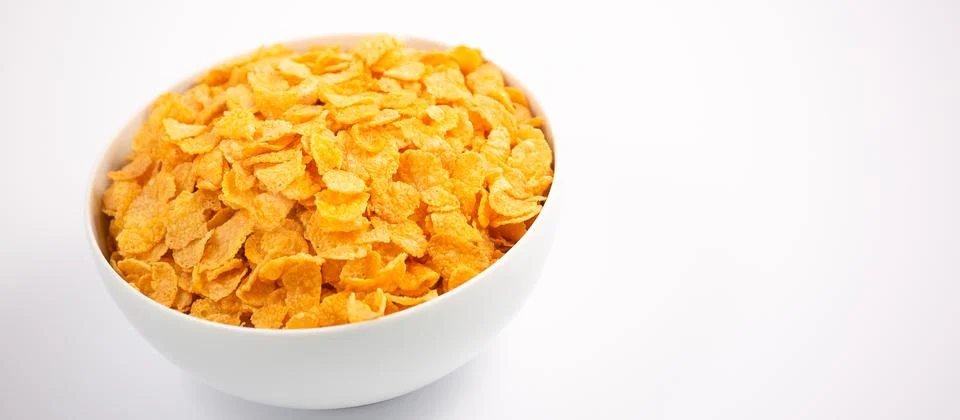 Natural corn flake breakfast cereal in cups and milk is a healthy breakfast t Stock Photos