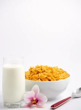 Natural corn flake breakfast cereal in cups and milk is a healthy breakfast t Stock Photos
