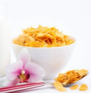 Natural corn flake breakfast cereal in cups and milk is a healthy breakfast t Stock Photos