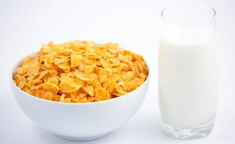 Natural corn flake breakfast cereal in cups and milk is a healthy breakfast t Stock Photos